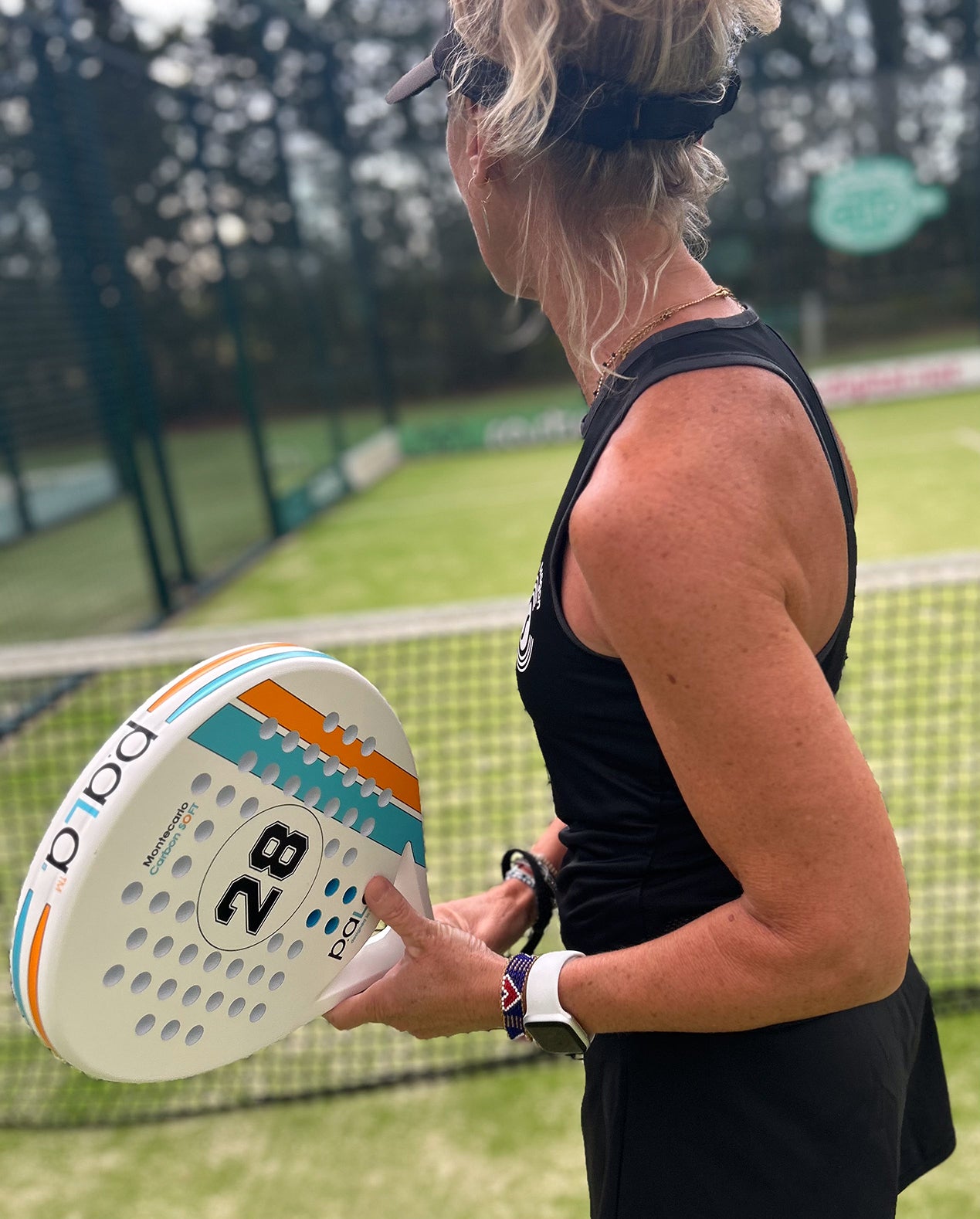 padel racket pala montercarlo in a padel court with a woman holding the racket 