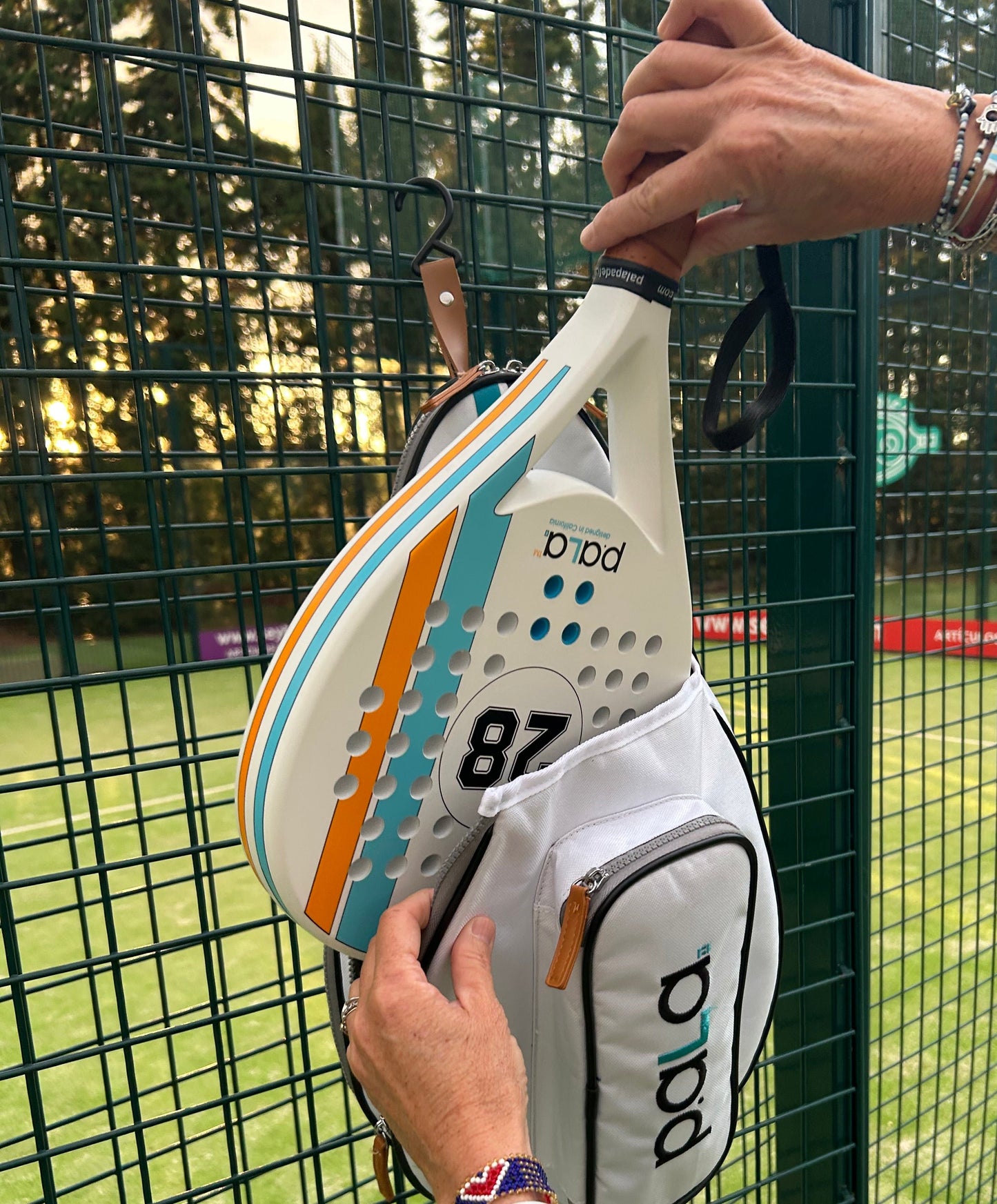 padel-racket-white-pala-padel-bag-pala-padel-usa with fence hook